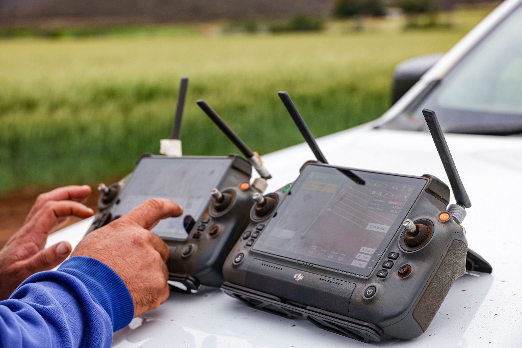 Two handheld controllers on a vehicle hood